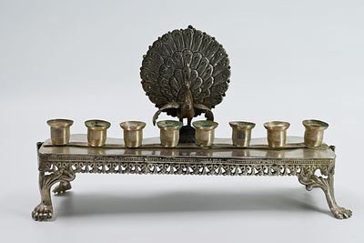Peacock Silver Menorah. 
The back of the menorah is decorated with a peacock, four lion legs 