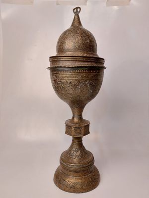 A large and impressive brass menorah, Qajar. Decorated with openwork and engraving of figures 