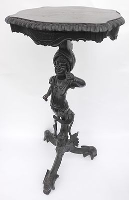 Black Forest. Serpentine top with a wood-cut finish. A bluester stand adorned with sculpted 