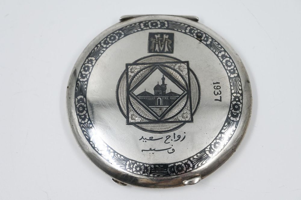 Silver Podria, Iraq, 1937, decorated with black Nilo work on both sides with a description of 