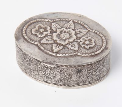 A tobacco box made of silver, sealed, oval, in a spectacular ballet work of flowers and 