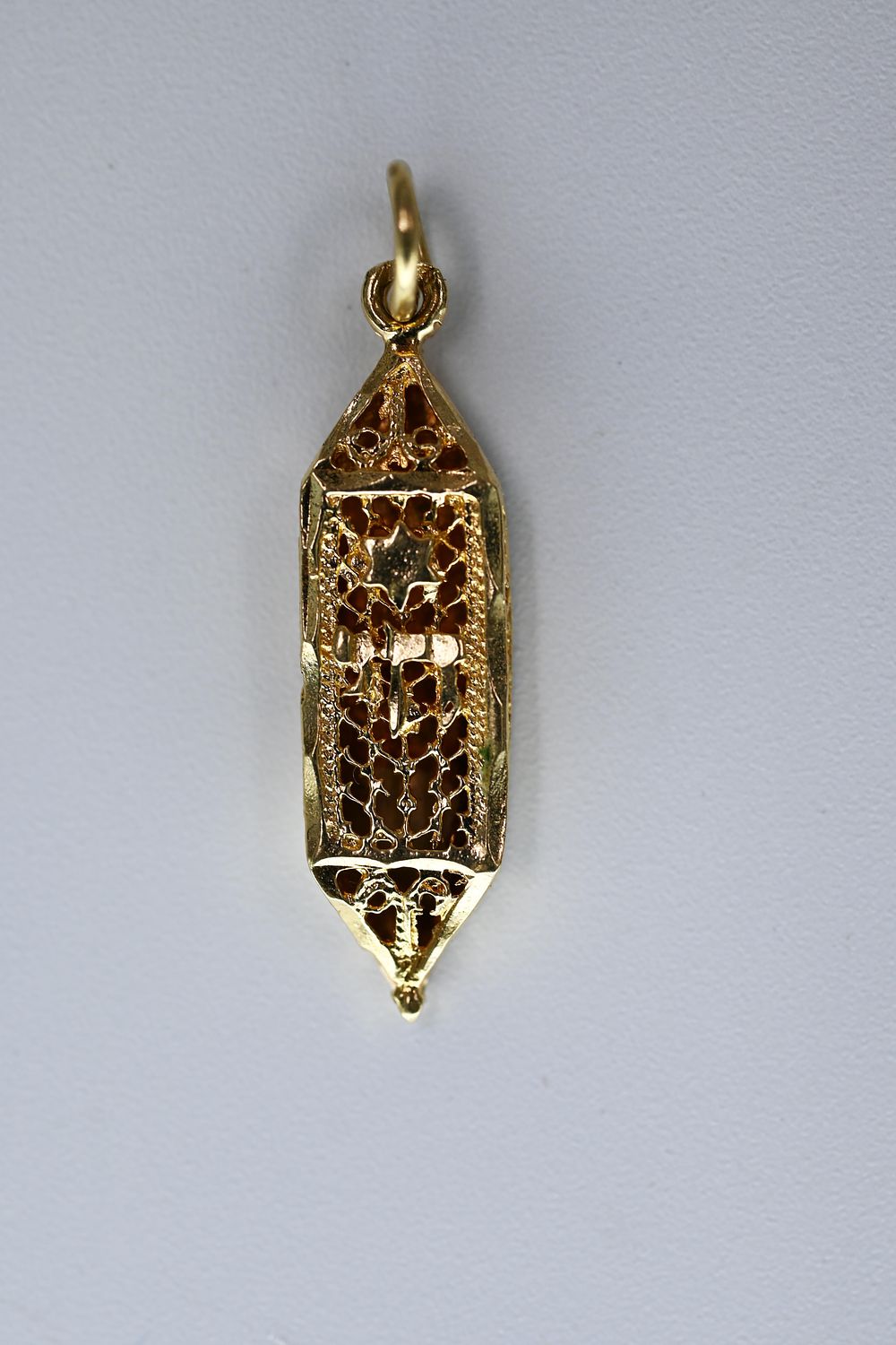 Gold Mezuzah Pendant. 
14K gold pendant in the shape of a mezuzah. Decorated with filigree 