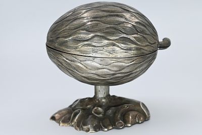 German silver etrog box, signed, late 19th century. Designed in the shape of an etrog resting 