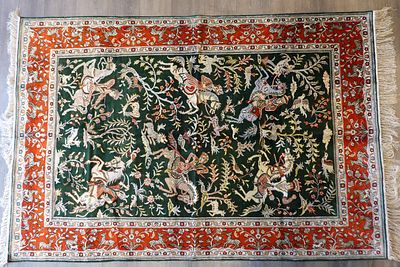 Chinese silk rug.Handmade Chinese silk rug. An impressive painting that includes hunters, wild 
