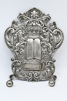 Flying to an impressive silver Torah book, master Lazarus Posen. 
Flying to an impressive 