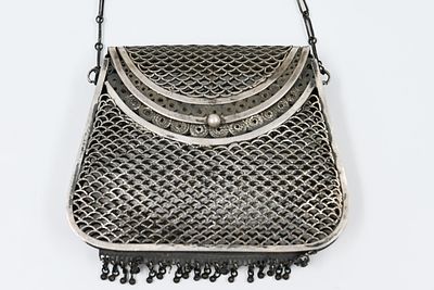 An antique silver mesh evening bag or purse (likely featuring filigree or fine silver-knit 