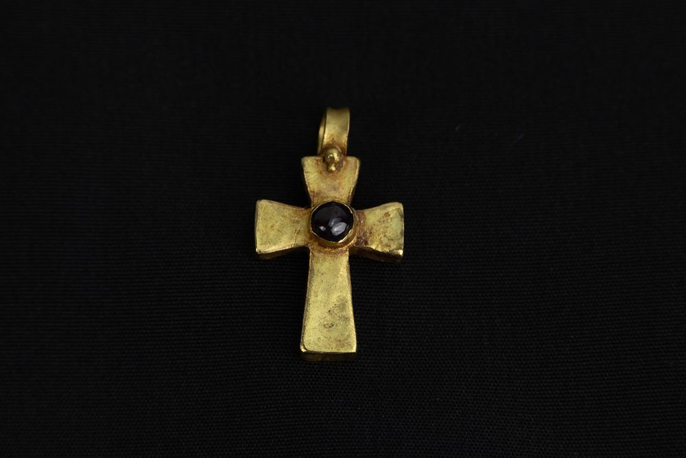 A Late Byzantine Gold Cross Pendant with Garnet Inset, 16th Century. 
The cross, with its 