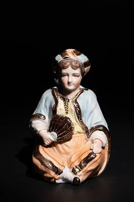 An Ottoman Ceramic Seated Man with Removable Head. This ceramic figurine represents a seated 