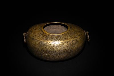 A Qajar Brass Kashkul Beggar's Bowl with Engraved Decorative Panels and Calligraphy. This Qajar 