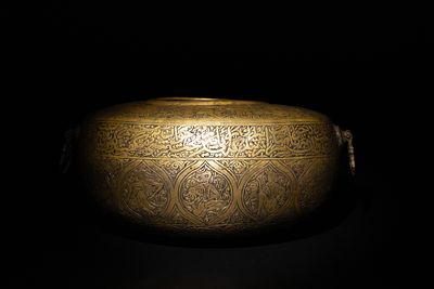 A Qajar Brass Kashkul Beggar's Bowl with Engraved Decorative Panels and Calligraphy. This Qajar 