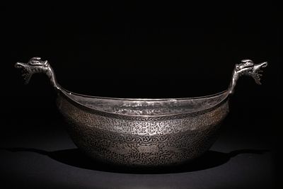 An Islamic Timurid Copper Kashkul Beggar's Bowl with Dragon-Headed Handles. A Timurid copper 