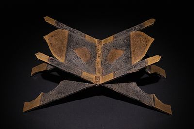 An Islamic Gold Inlaid Steel Quran Holder, 19th-20th Century. A steel Quran holder with gold 