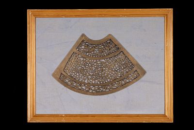 An Islamic Brass Openwork Calligraphic Plaque. A brass plaque with an intricate openwork design 