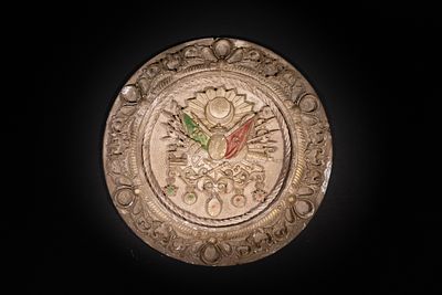 An Ottoman Cast Plaster Plaque with Imperial Coat of Arms. A round plaster plaque featuring a 