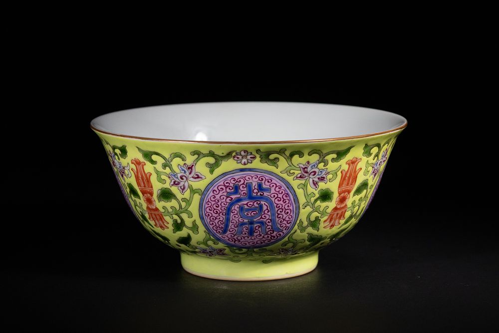 A Chinese Yellow Ground Famille Rose 'Shou' Longevity Bowl, Yongzheng Mark. A finely potted 