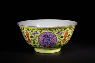 A Chinese Yellow Ground Famille Rose 'Shou' Longevity Bowl, Yongzheng Mark. A finely potted 