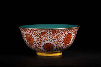 A Chinese Coral-Ground Lotus Scroll Bowl, Qianlong Mark. A finely potted porcelain bowl, known 