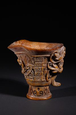 A Chinese Carved Libation Cup, Qianlong Mark. A carved libation cup, or rhyton, crafted from a 