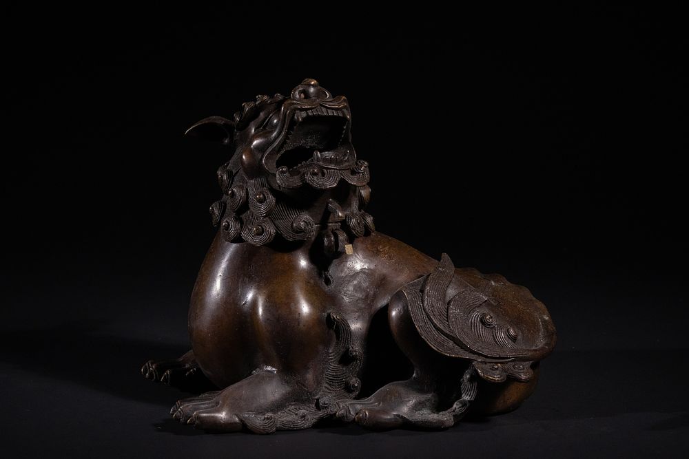 A Chinese Bronze Lion Censer, 19th Century. A patinated bronze figure of an East Asian-style 