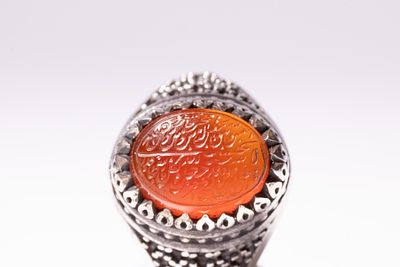 AN ISLAMIC SILVER AND INTAGLIO-CARVED CARNELIAN SIGNET RING WITH MAKER'S MARK FOR SHA'BAN. An 