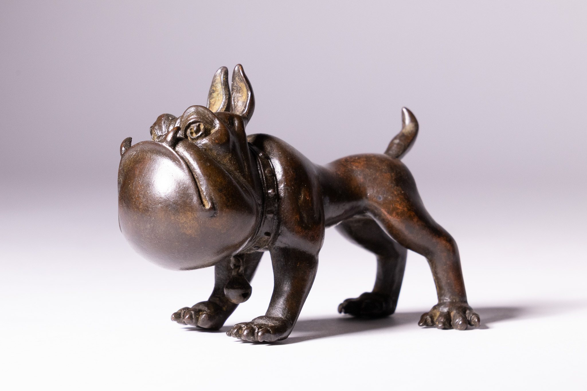 A JAPANESE BRONZE FIGURE OF A CARICATURED BULLDOG.