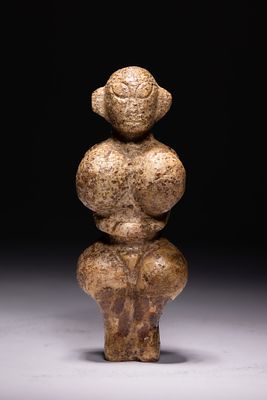 A NEOLITHIC STYLE STONE FEMALE FIGURINE (VENUS TYPE), POSSIBLY CIRCA 3000–2000 BC. A carved 