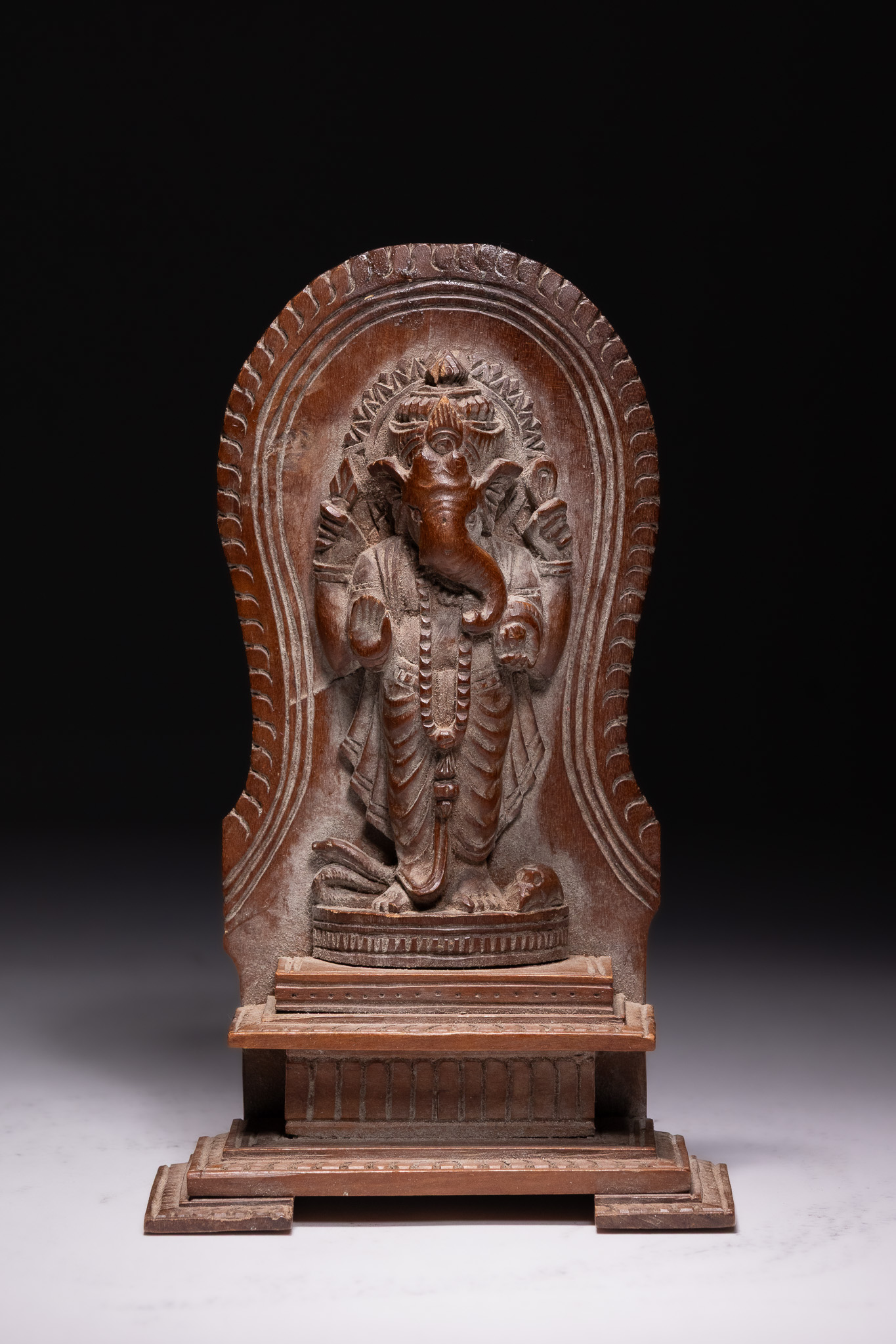 A SOUTH INDIAN CARVED HARDWOOD RELIEF SCULPTURE OF GANESHA, 20TH CENTURY.