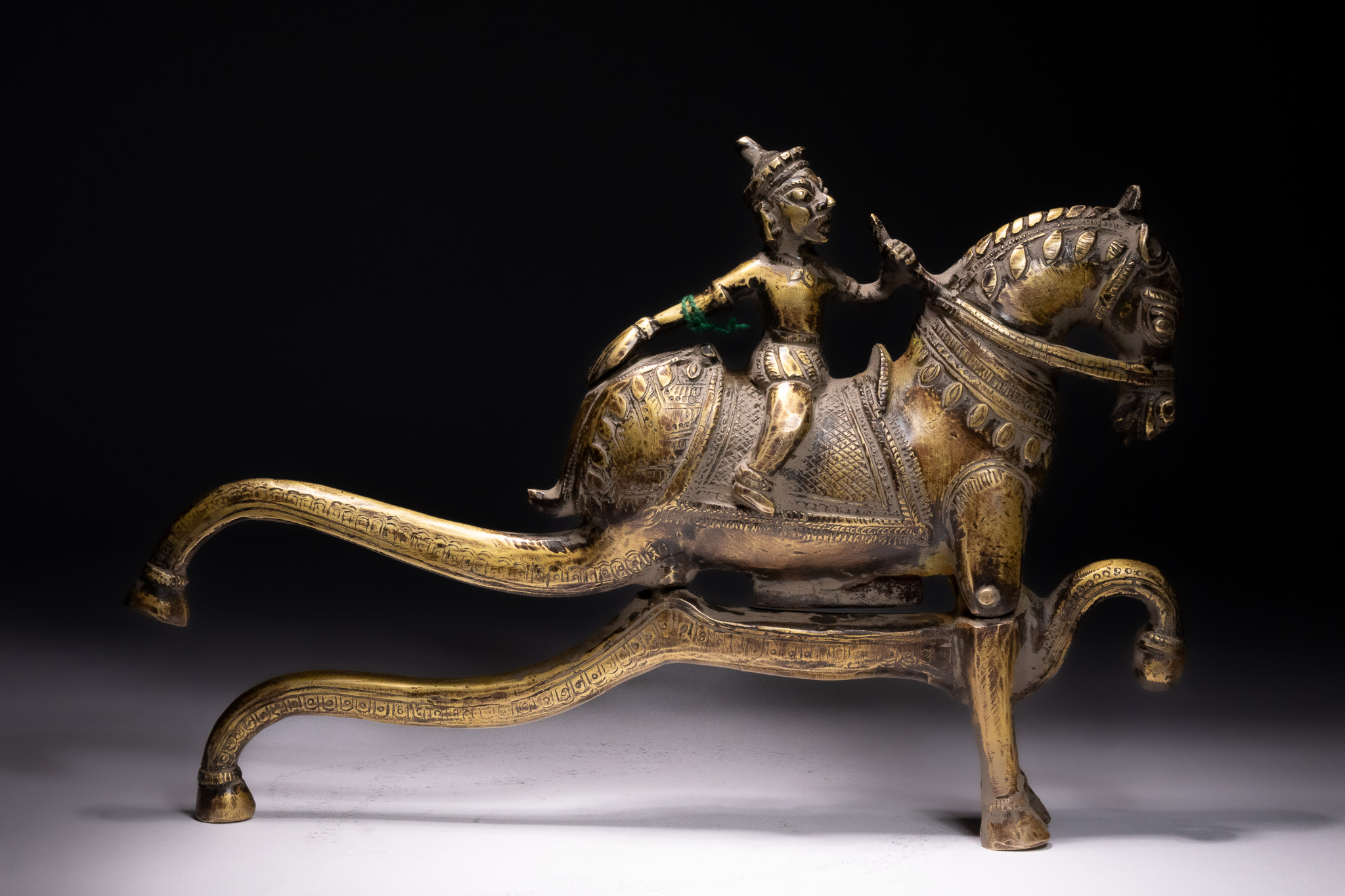 A LARGE SOUTH INDIAN BRASS BETEL NUT CUTTER IN THE FORM OF AIYANAR ON HORSEBACK, 18TH-19TH CENTURY.