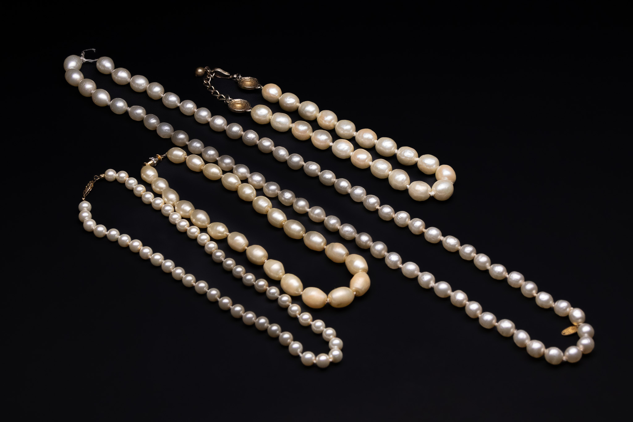 A COLLECTION OF CULTURED PEARL NECKLACES WITH GOLD-TONE CLASPS.