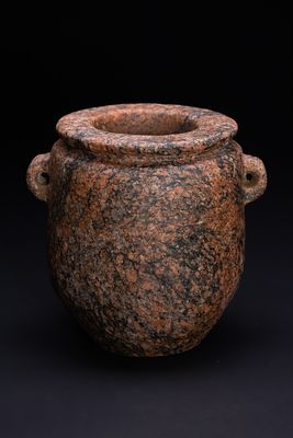 AN ANCIENT EGYPTIAN PREDYNASTIC RED GRANITE JAR, 3500-2700 BC. This stone vessel is a 