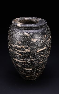 AN ANCIENT EGYPTIAN GRANITE OVOID JAR, CIRCA 4TH-3RD MILLENNIUM BC. This stone vessel is carved 