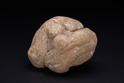 A NEOLITHIC STONE SCULPTURE OF INTERTWINED HUMAN FIGURES, CIRCA 5000–3000 BC. A carved stone 