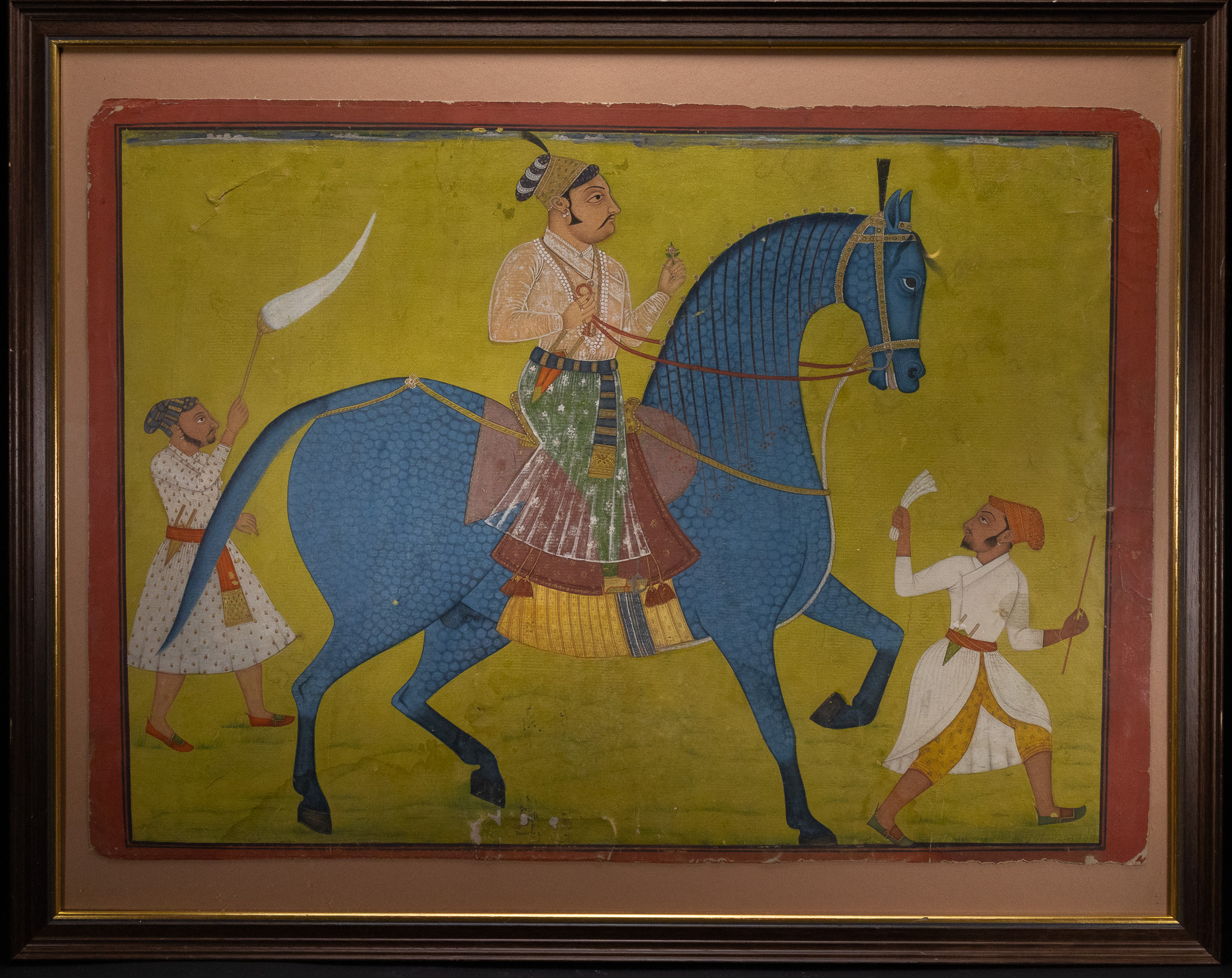 A LARGE RAJASTHAN SCHOOL MINIATURE PAINTING OF A NOBLEMAN ON A BLUE HORSE, LATE 18TH/EARLY 19TH CENTURY.