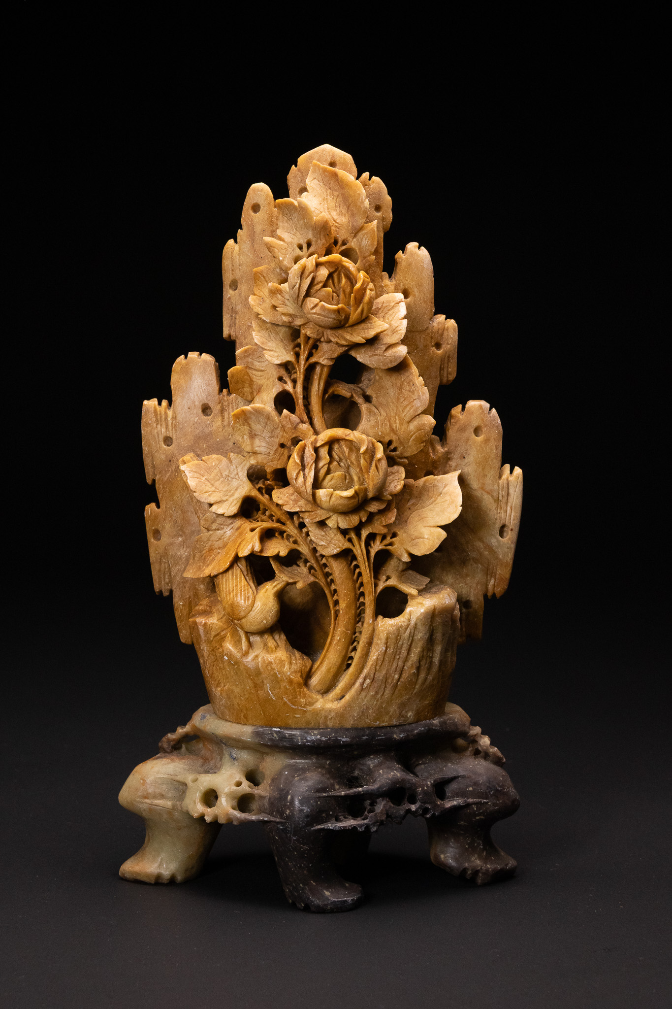 A CHINESE CARVED STONE GROUP OF PEONIES AND ROCKWORK.