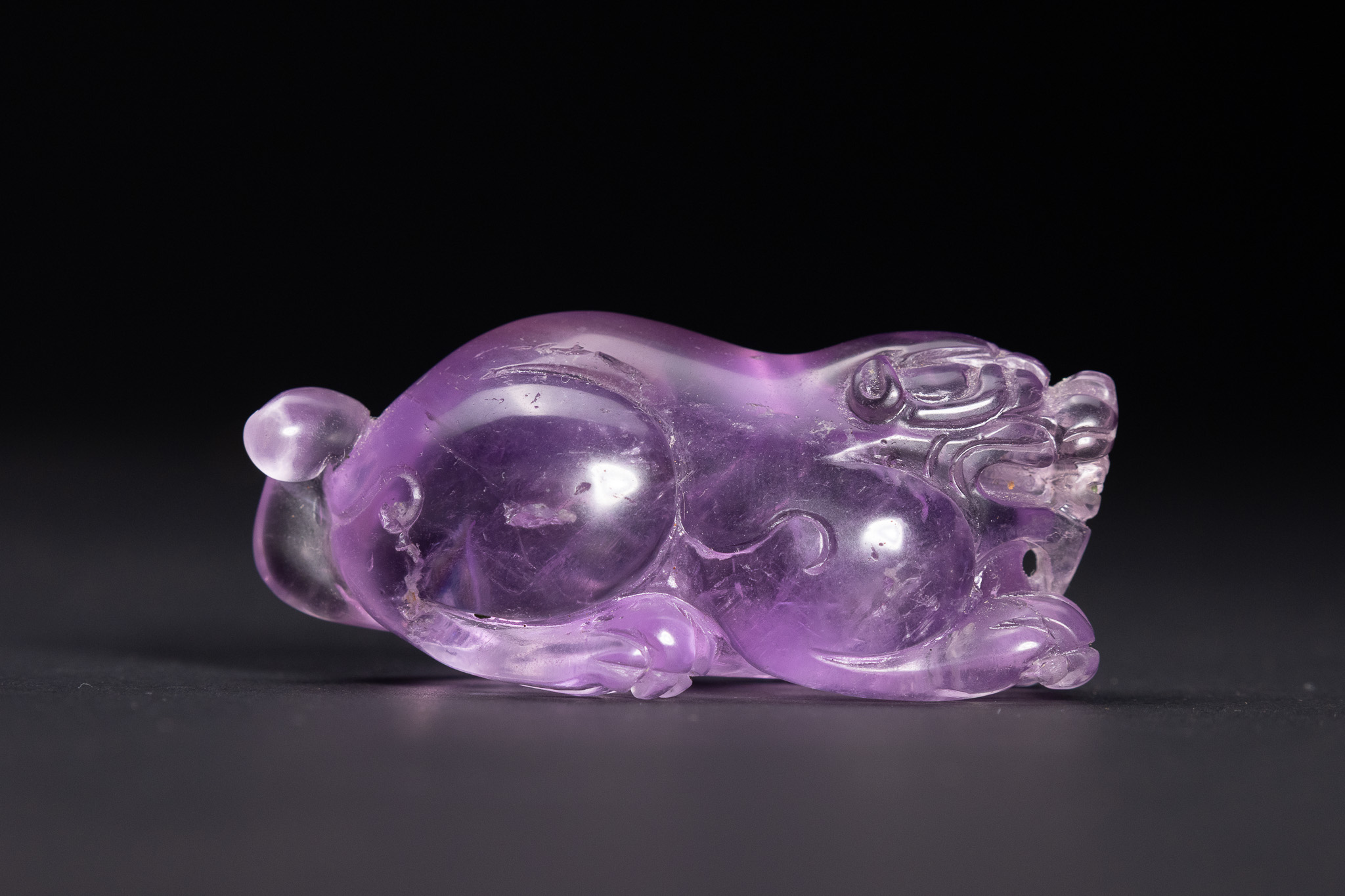 A CHINESE CARVED AMETHYST FIGURE OF A MYTHICAL BEAST, BIXIE.