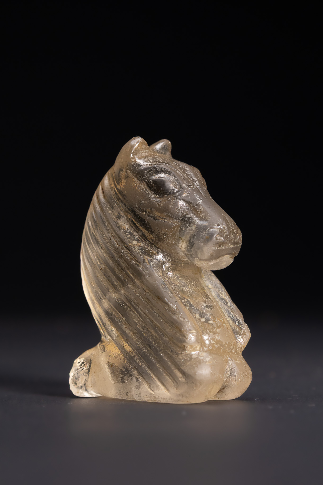 AN ISLAMIC CARVED ROCK CRYSTAL KNIGHT CHESS PIECE, POSSIBLY FATIMID PERIOD.