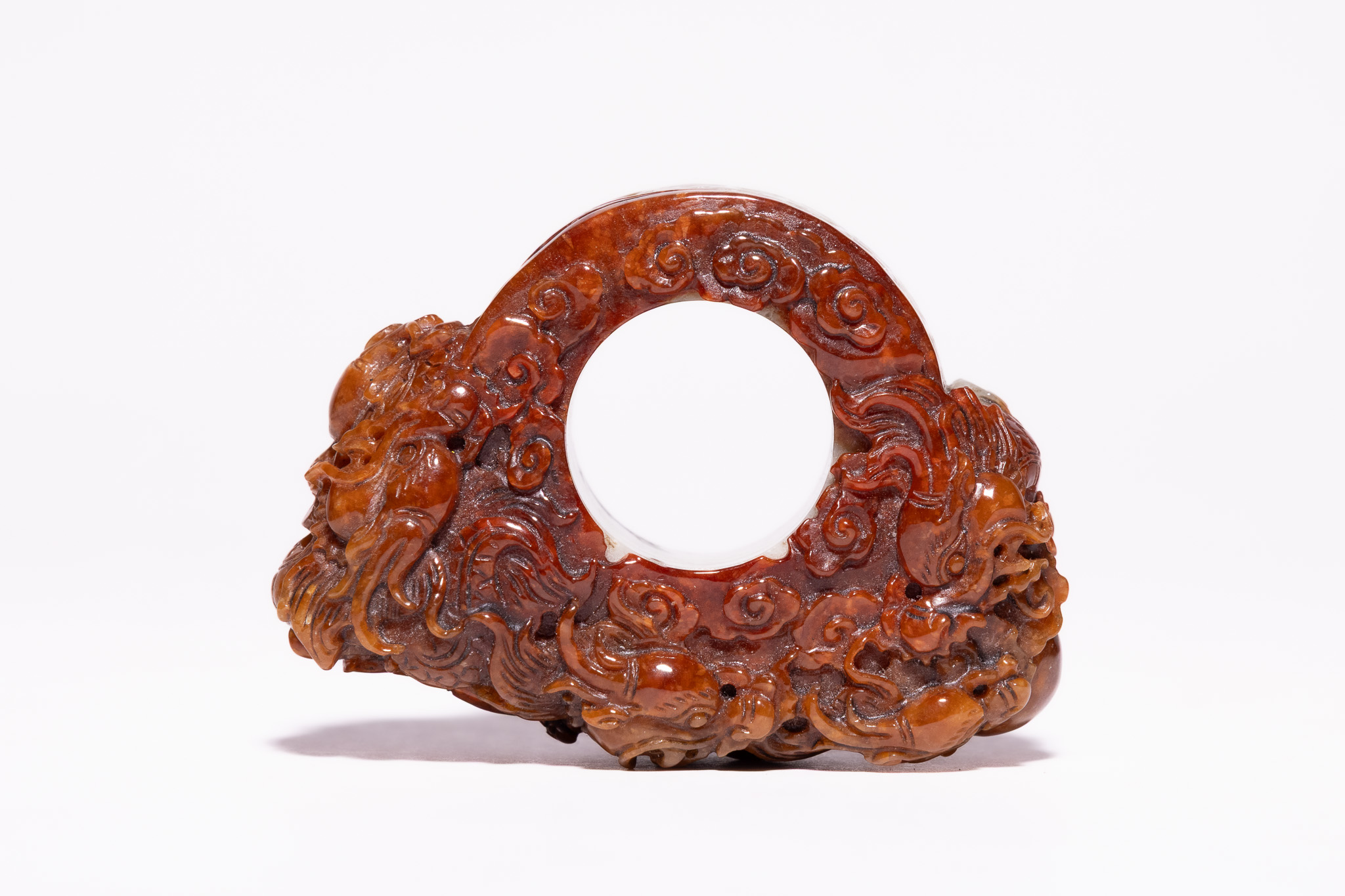 A RARE CHINESE CARVED TWO-TONE NEPHRITE JADE DRAGON BI-DISC ORNAMENT.
