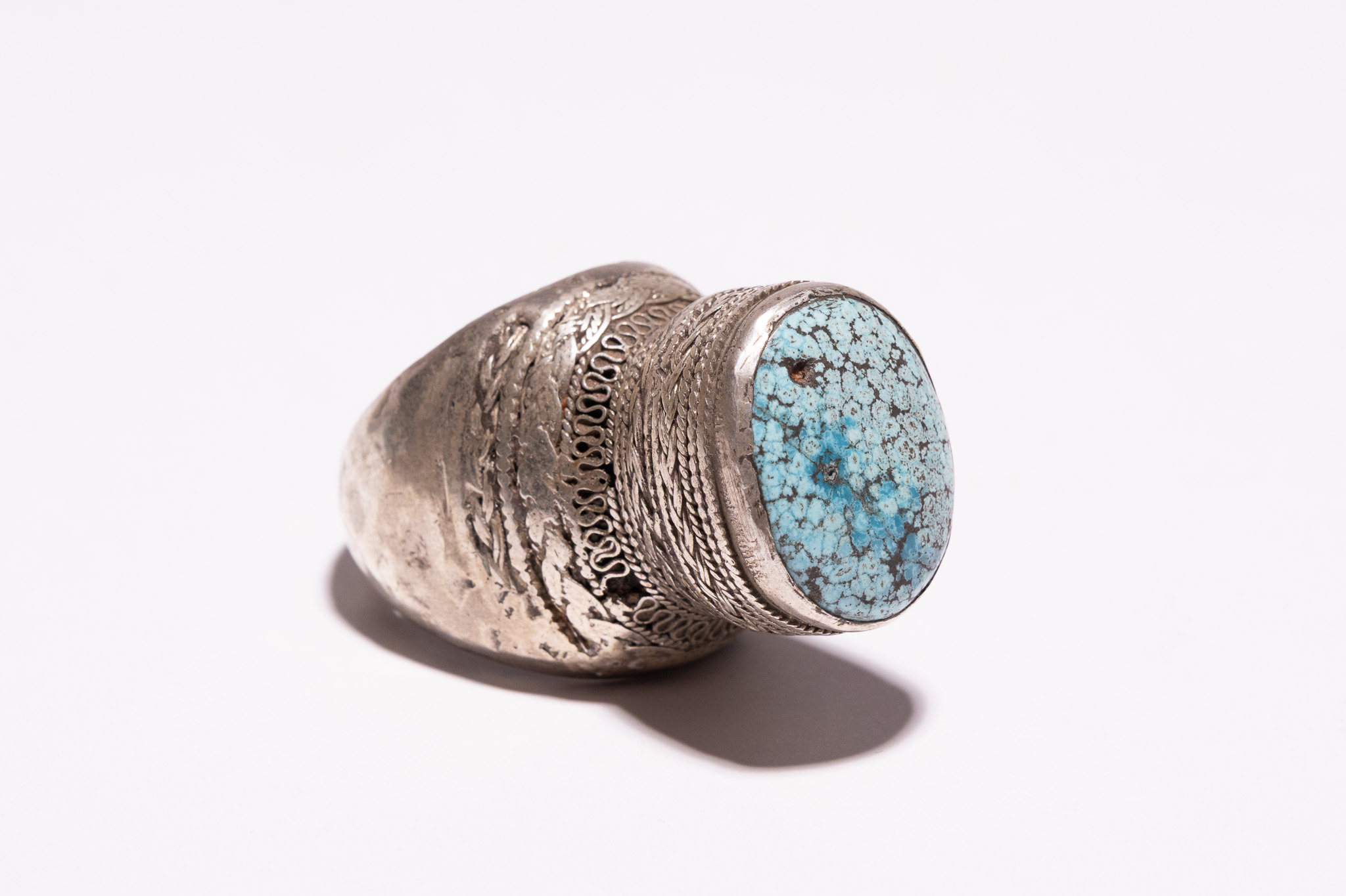 A TRIBAL SILVER AND TURQUOISE STATEMENT RING.