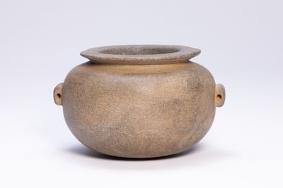 A PREDYNASTIC EGYPTIAN STONE LUG-HANDLED VESSEL, CIRCA 3000 B.C. The piece is fashioned from a 