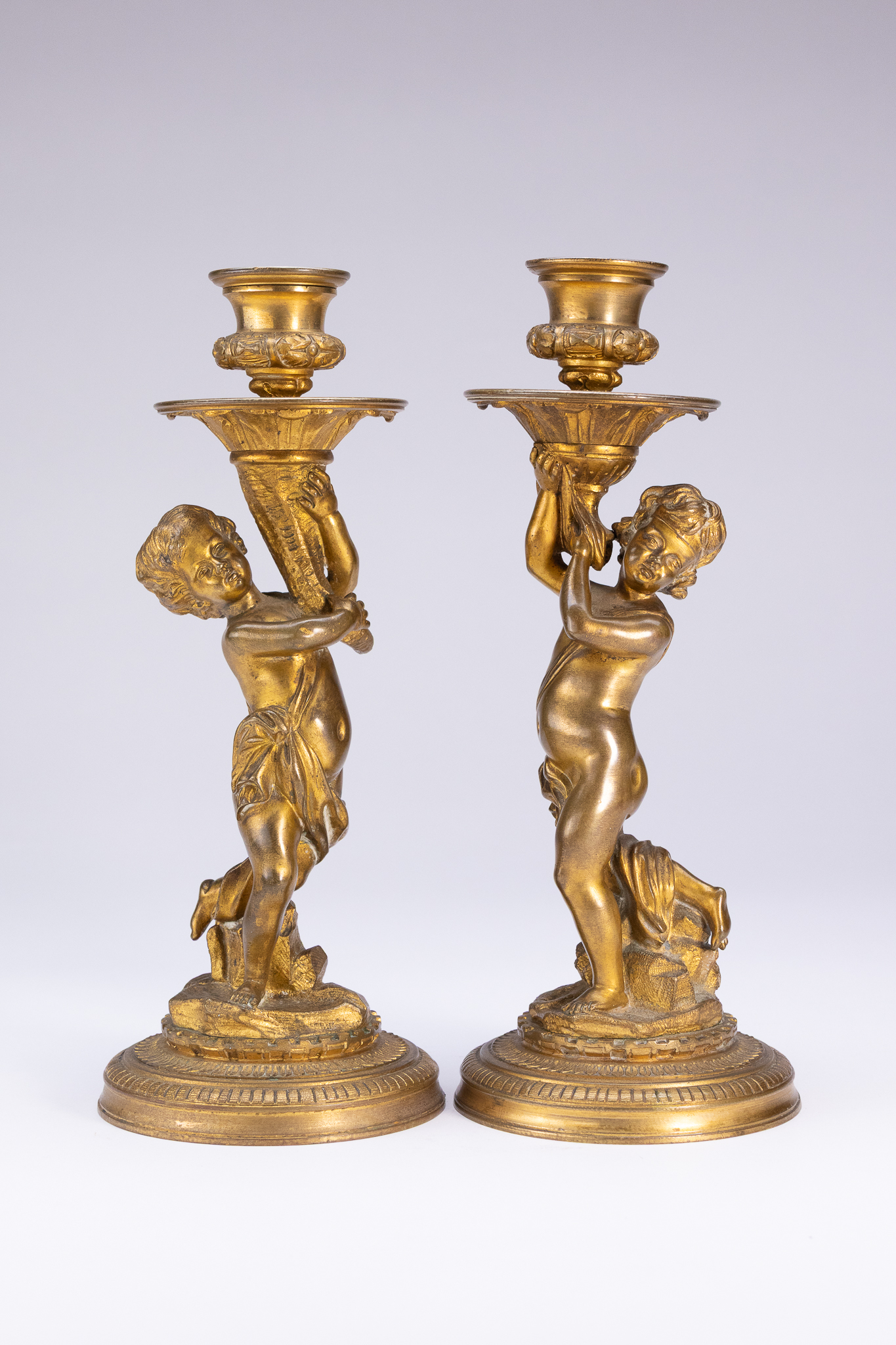 A PAIR OF FRENCH NEOCLASSICAL GILT-BRONZE FIGURAL CANDLESTICKS, 19TH CENTURY.