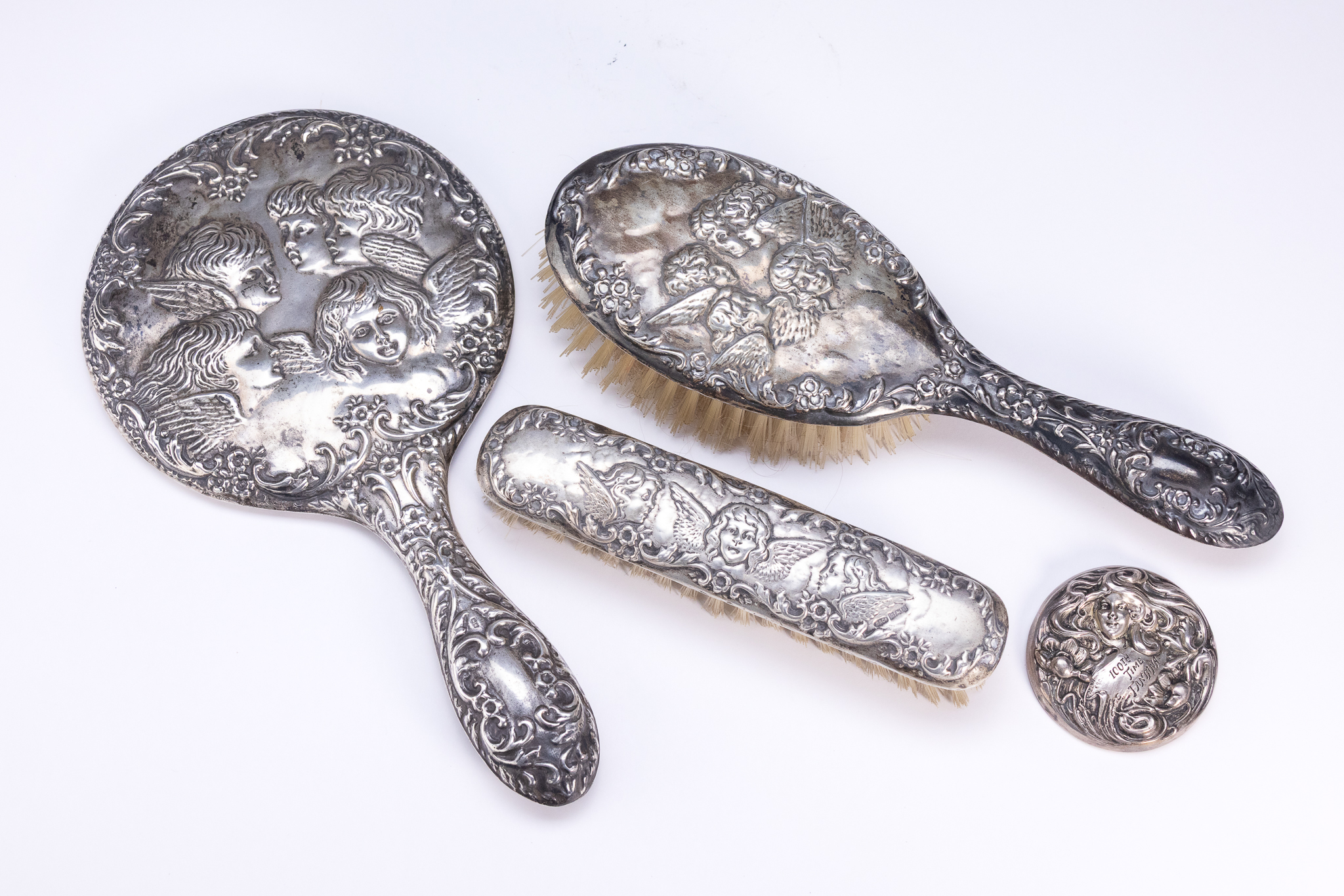 A SET OF BIRMINGHAM HALLMARKED STERLING SILVER DRESSING TABLE ACCESSORIES WITH REYNOLDS' ANGELS MOTIF