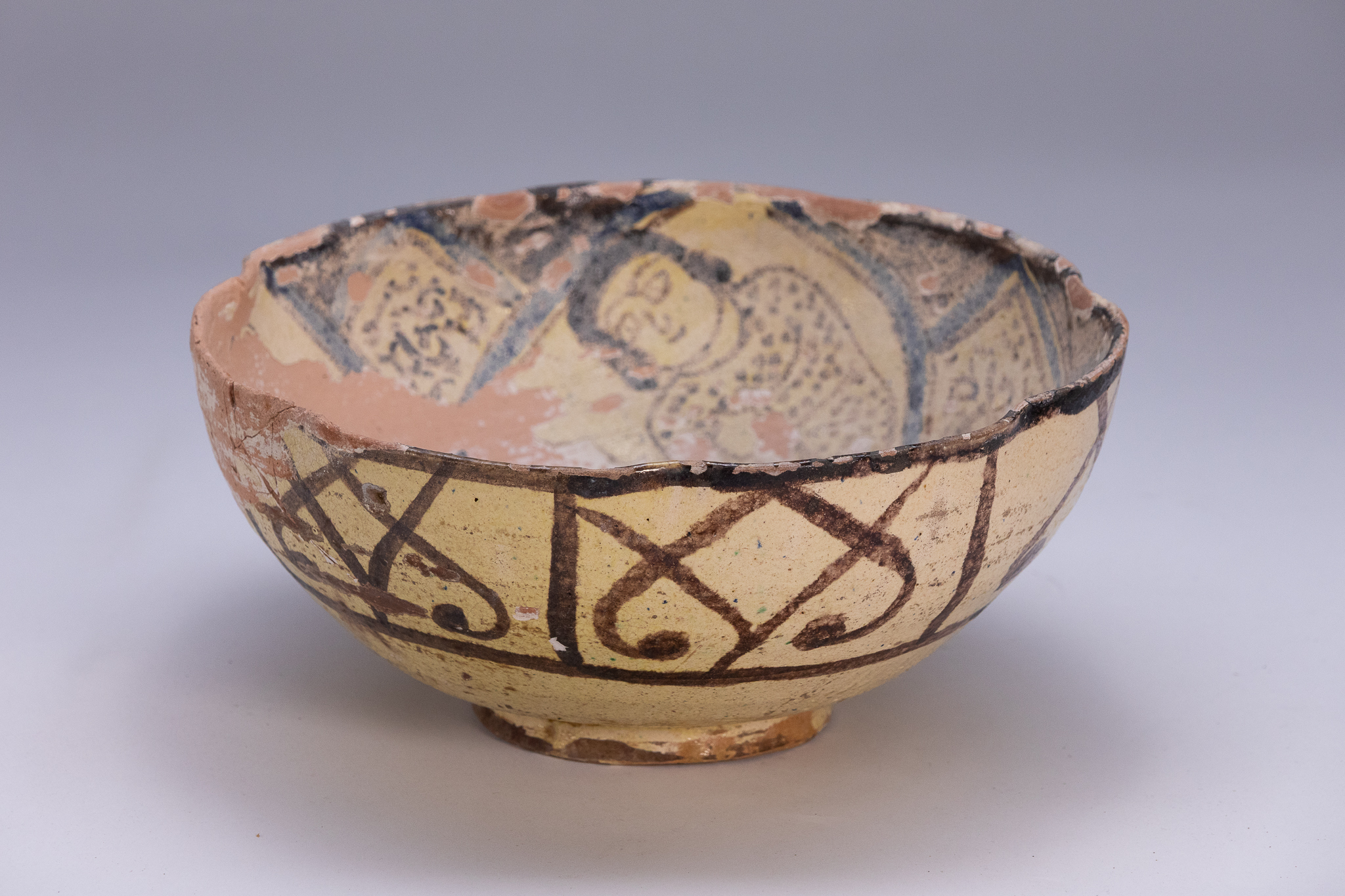 A PERSIAN FIGURAL CERAMIC BOWL IN THE NISHAPUR STYLE.