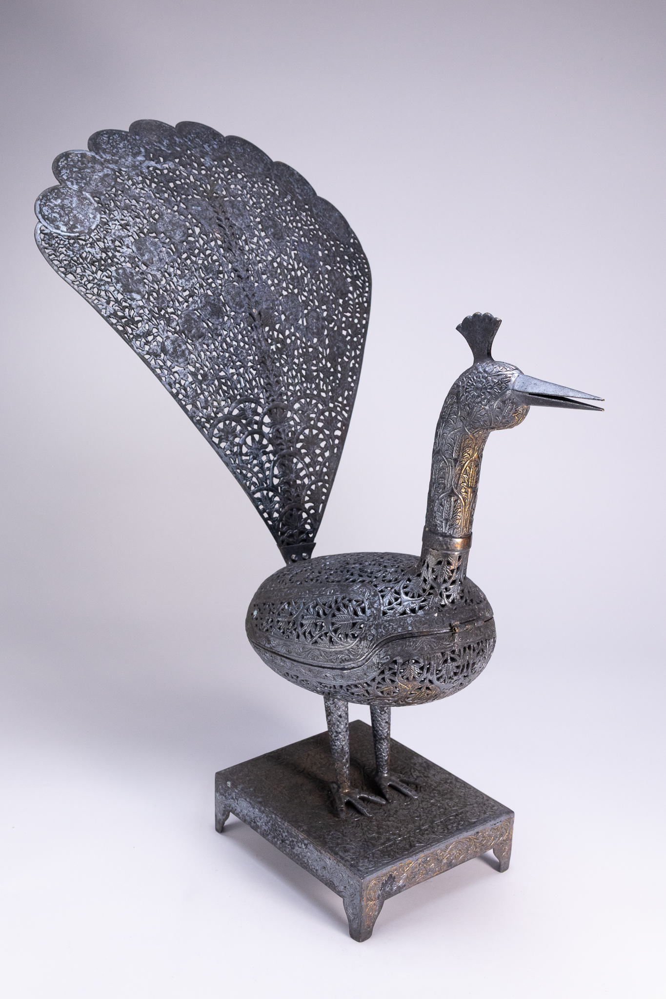 A QAJAR STYLE OPENWORK STEEL PEACOCK INCENSE BURNER.