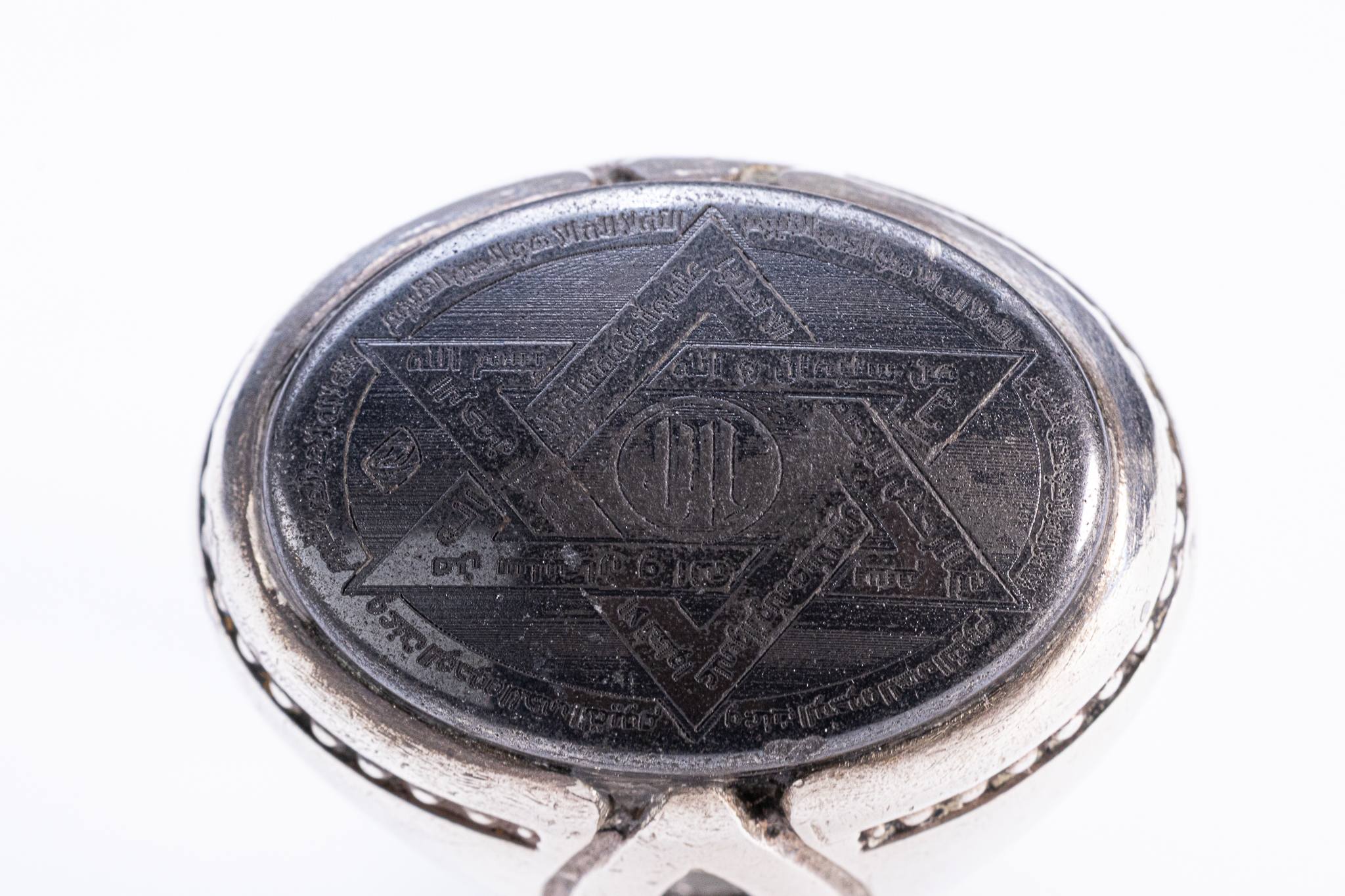 A SILVER AND HEMATITE TALISMANIC SEAL OF SOLOMON RING.