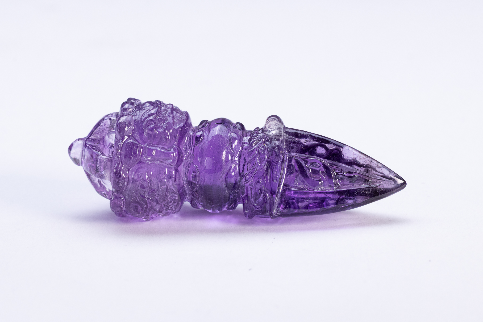 A CARVED AMETHYST PHURBA RITUAL DAGGER.