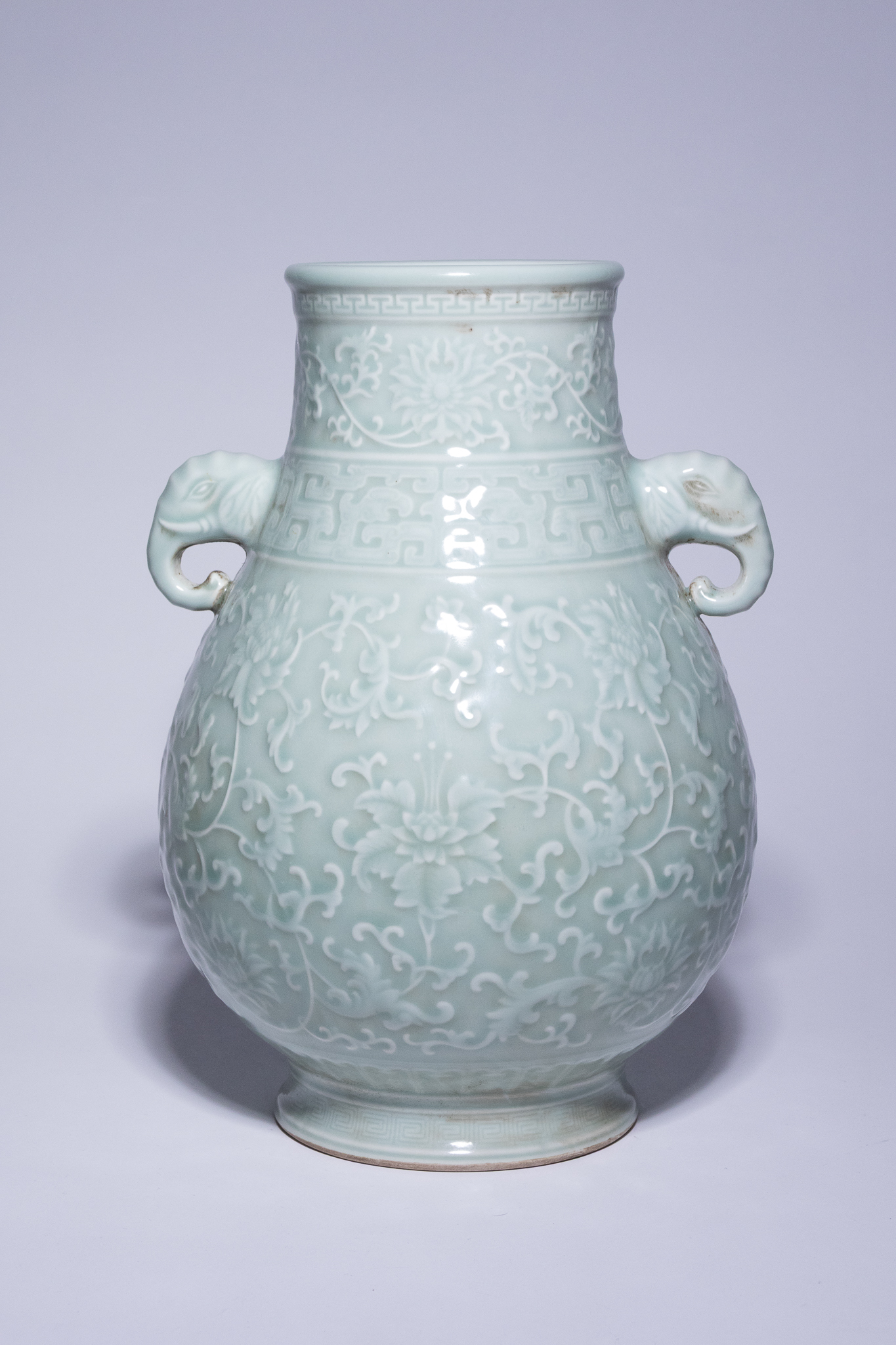 A CHINESE CELADON GLAZED PORCELAIN ELEPHANT HANDLE VASE, QIANLONG MARK.