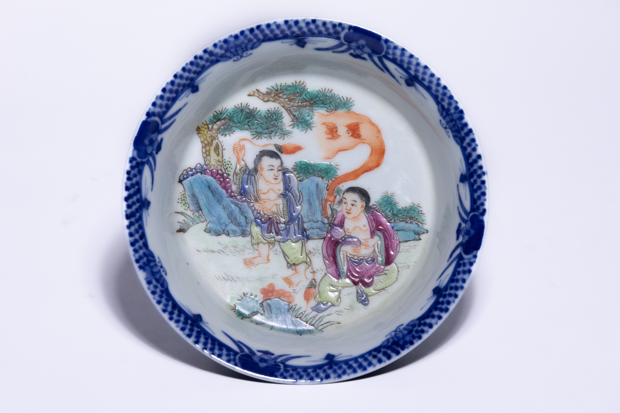 A CHINESE POWDER BLUE AND FAMILLE ROSE PORCELAIN SAUCER DISH, XUANTONG MARK.