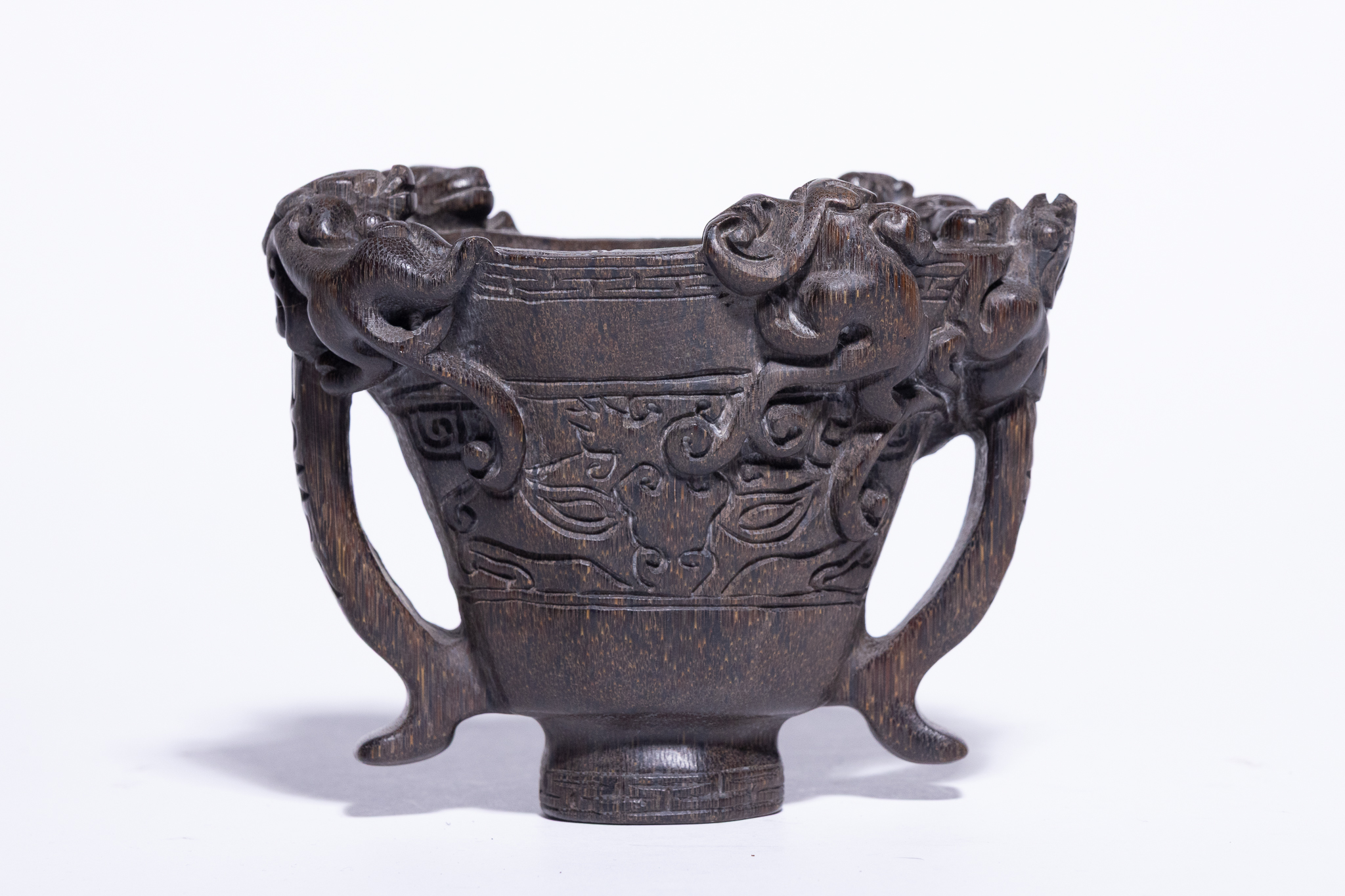 A CHINESE CARVED ARCHAISTIC LIBATION CUP, QIANLONG MARK.