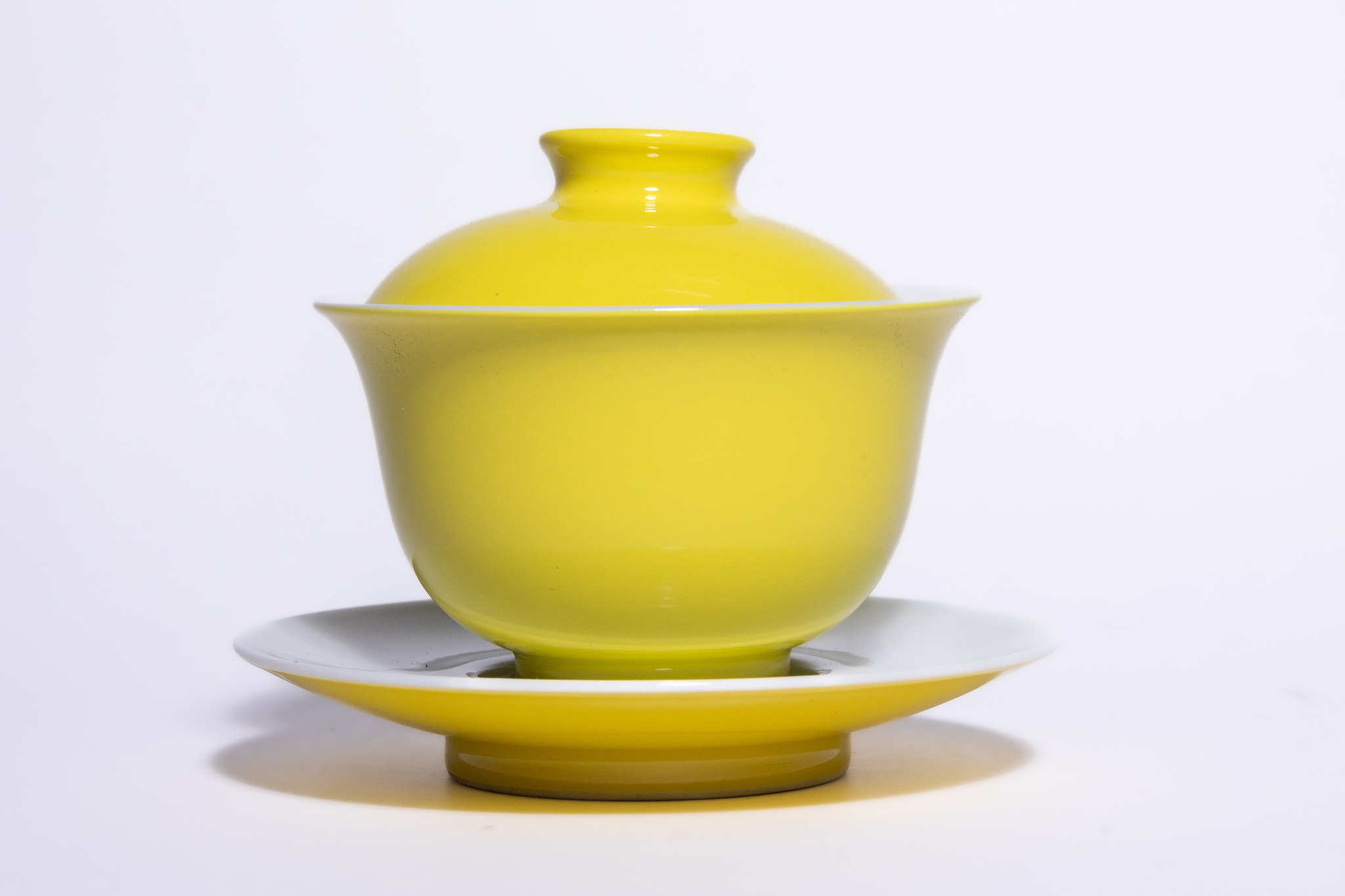 A CHINESE MONOCHROME YELLOW-GLAZED PORCELAIN GAIWAN AND SAUCER, YONGZHENG MARK.