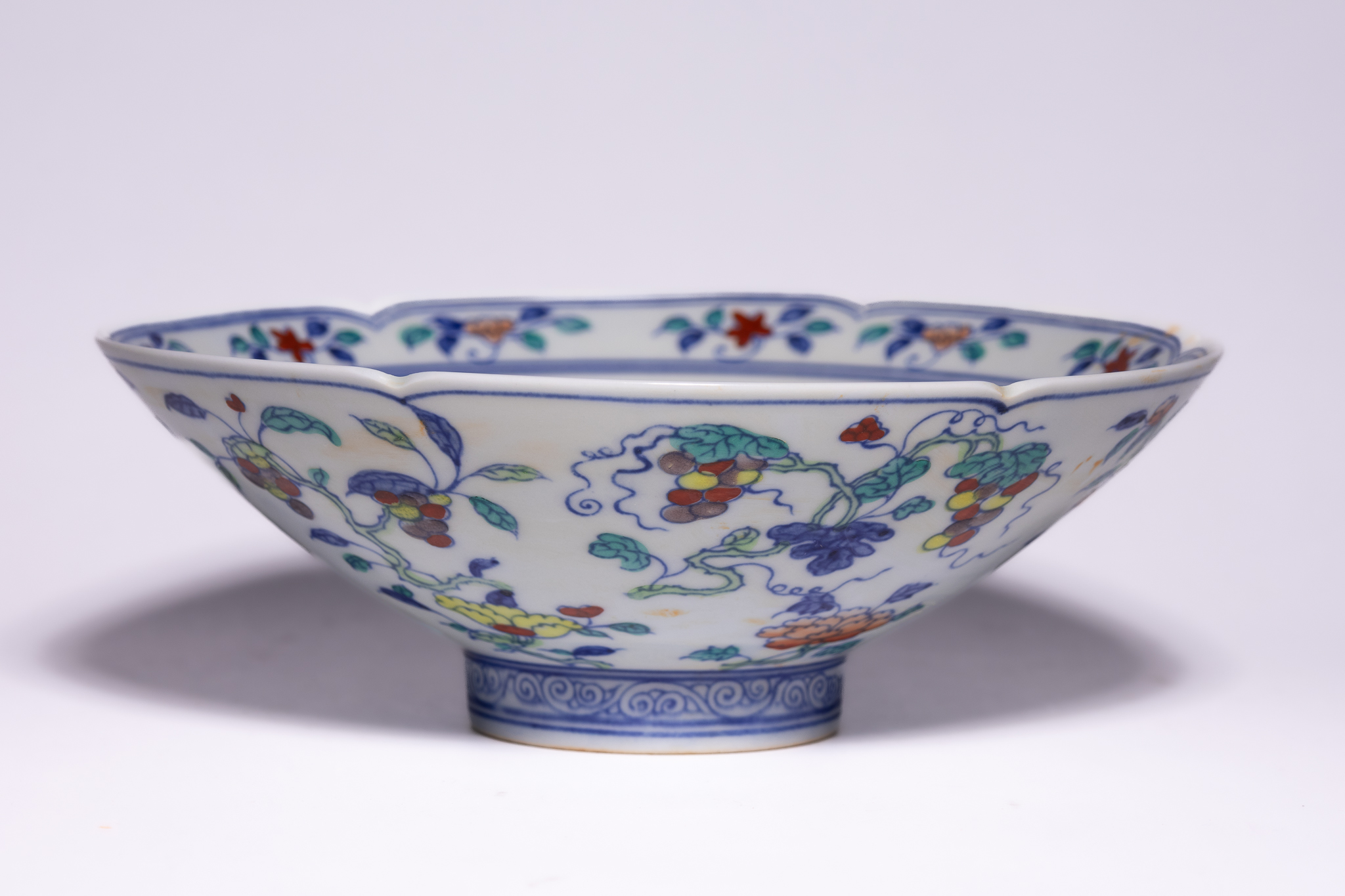 A CHINESE DOUCAI FRUITING VINE LOBED PORCELAIN BOWL, CHENGUA MARK.